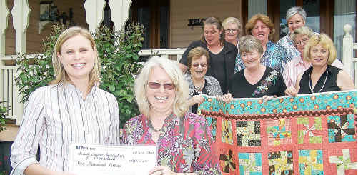 Jayne Gentry accepting a donation from Glenis Pugliese and the Glenrose Patchwork crew. Jayne Gentry accepting a donation from Glenis Pugliese and the Glenrose Patchwork crew.